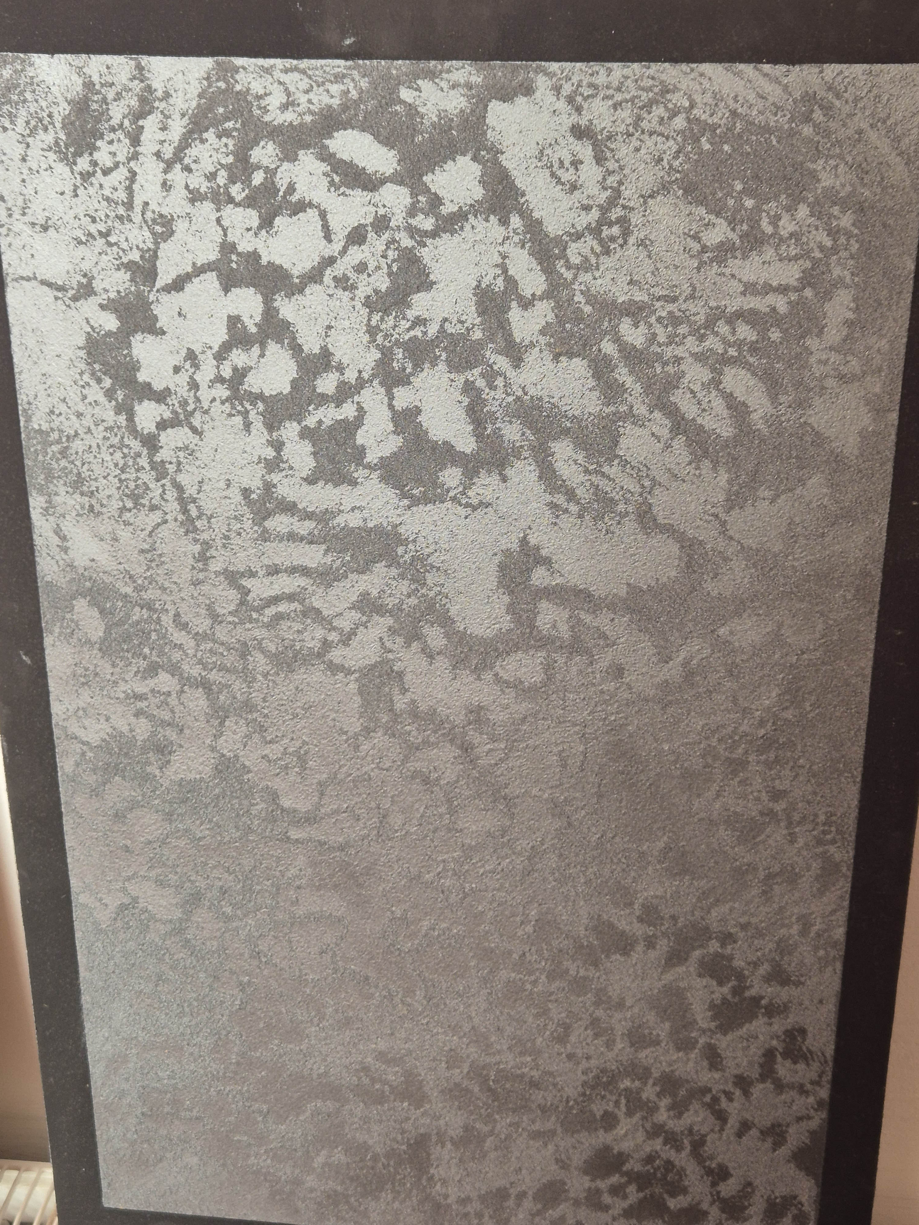 Dark grey textured decorative plaster sample