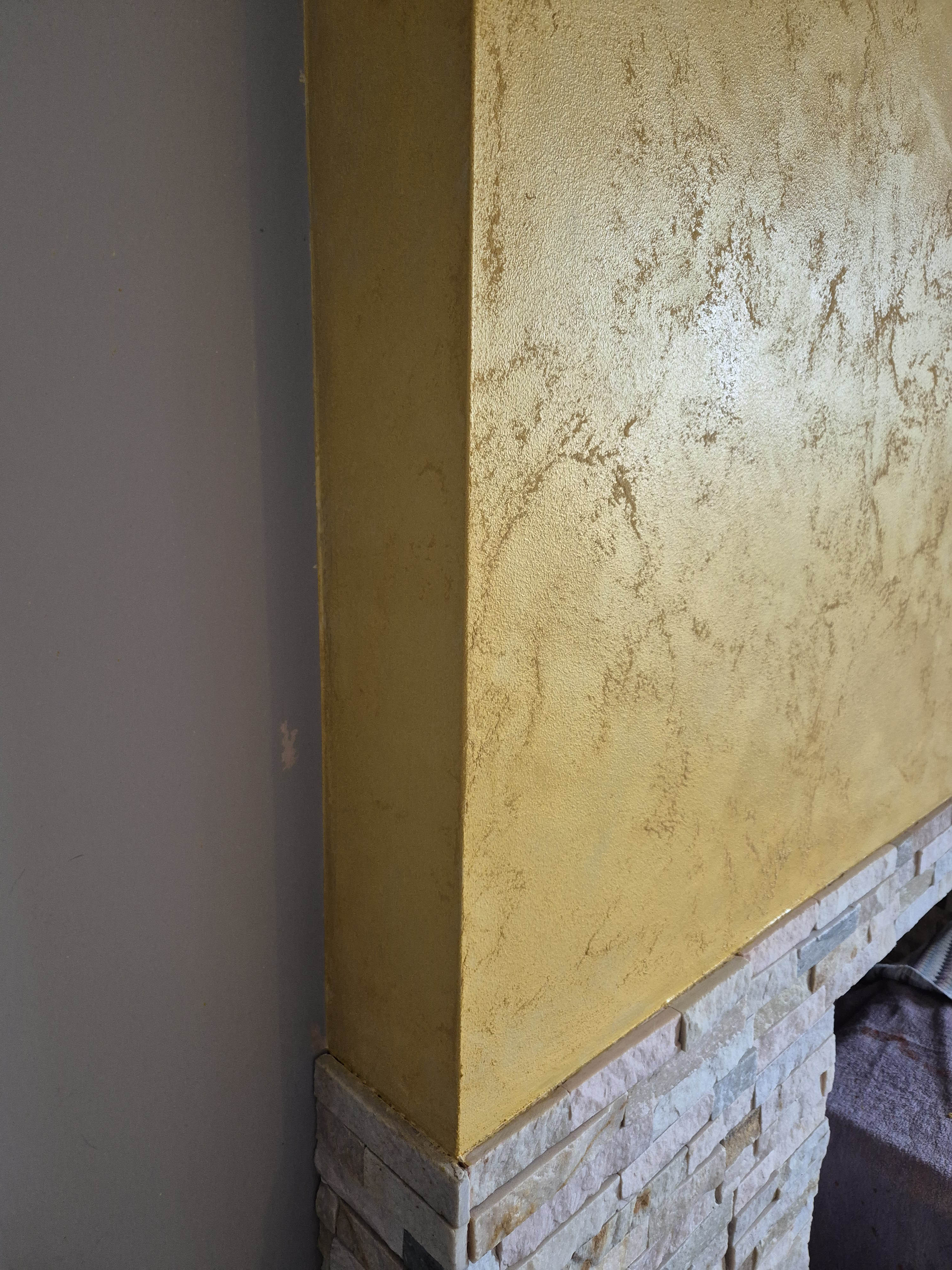 Gold metallic polished plaster finish showcasing specialist Venetian plaster craftsmanship